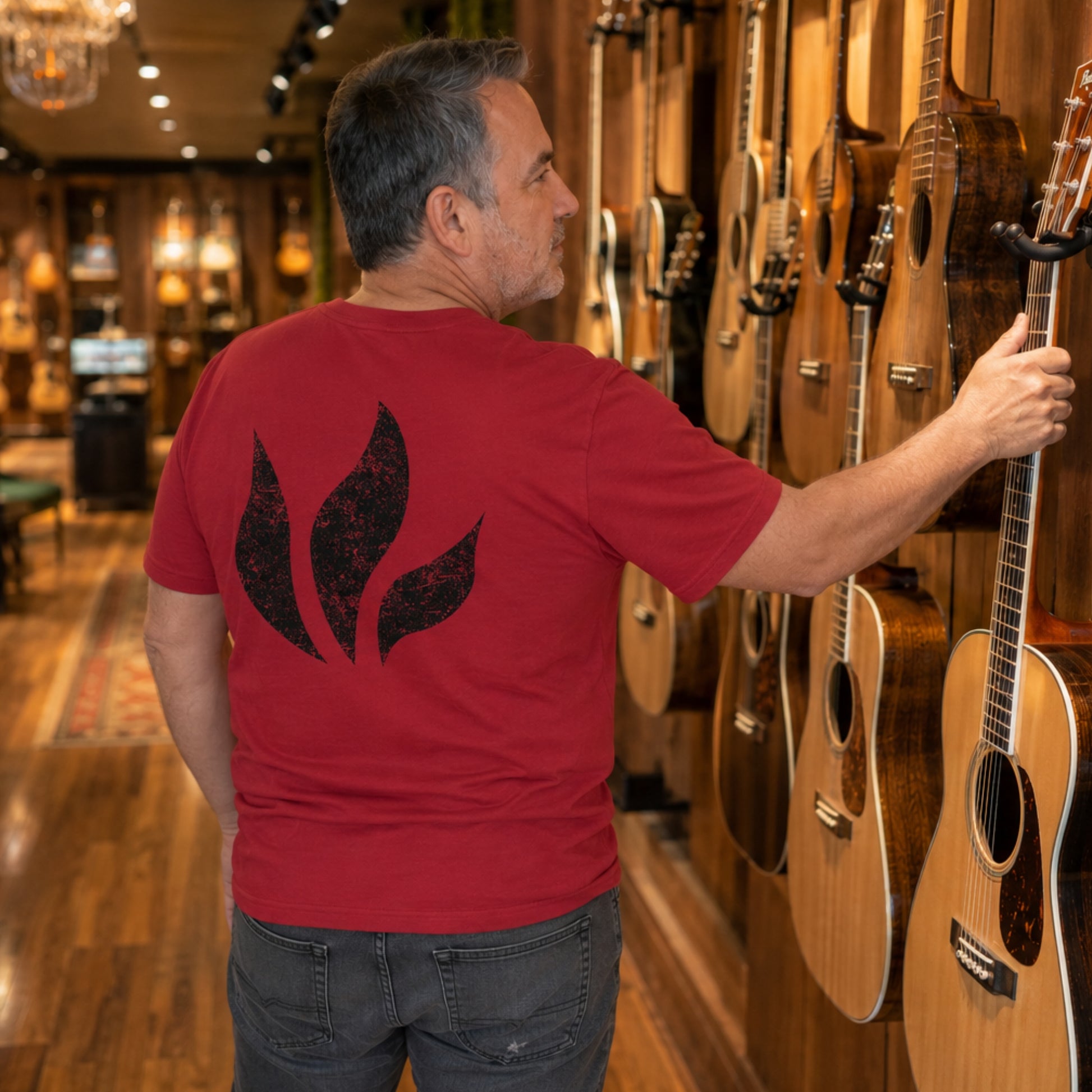 A man wearing the Blue October Red Foiled Flame back T-shirt.