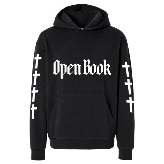 Black hoodie with 'Open Book' text and cross designs on sleeves against a white background