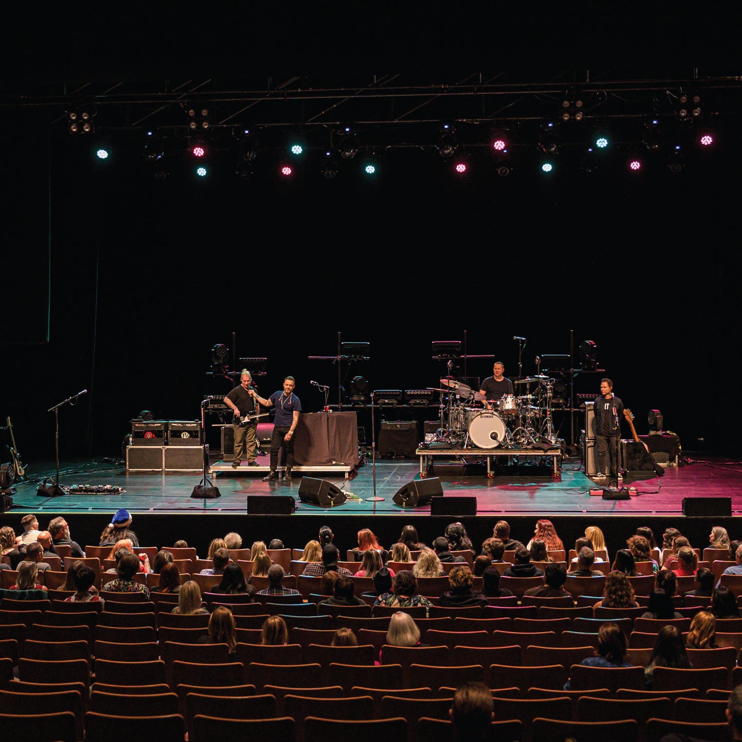 Band performing on stage with audience in a theater setting - Blue October's VIP Meet & Greet